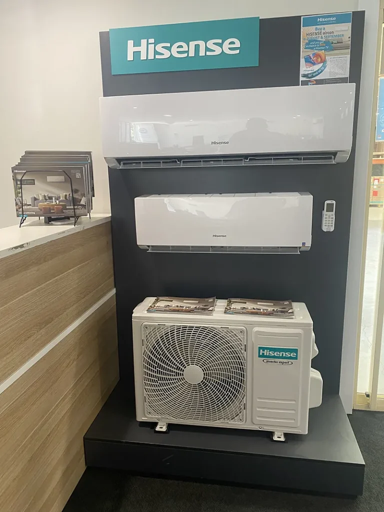 Hisense outdoor condenser unit installed on a display plinth
